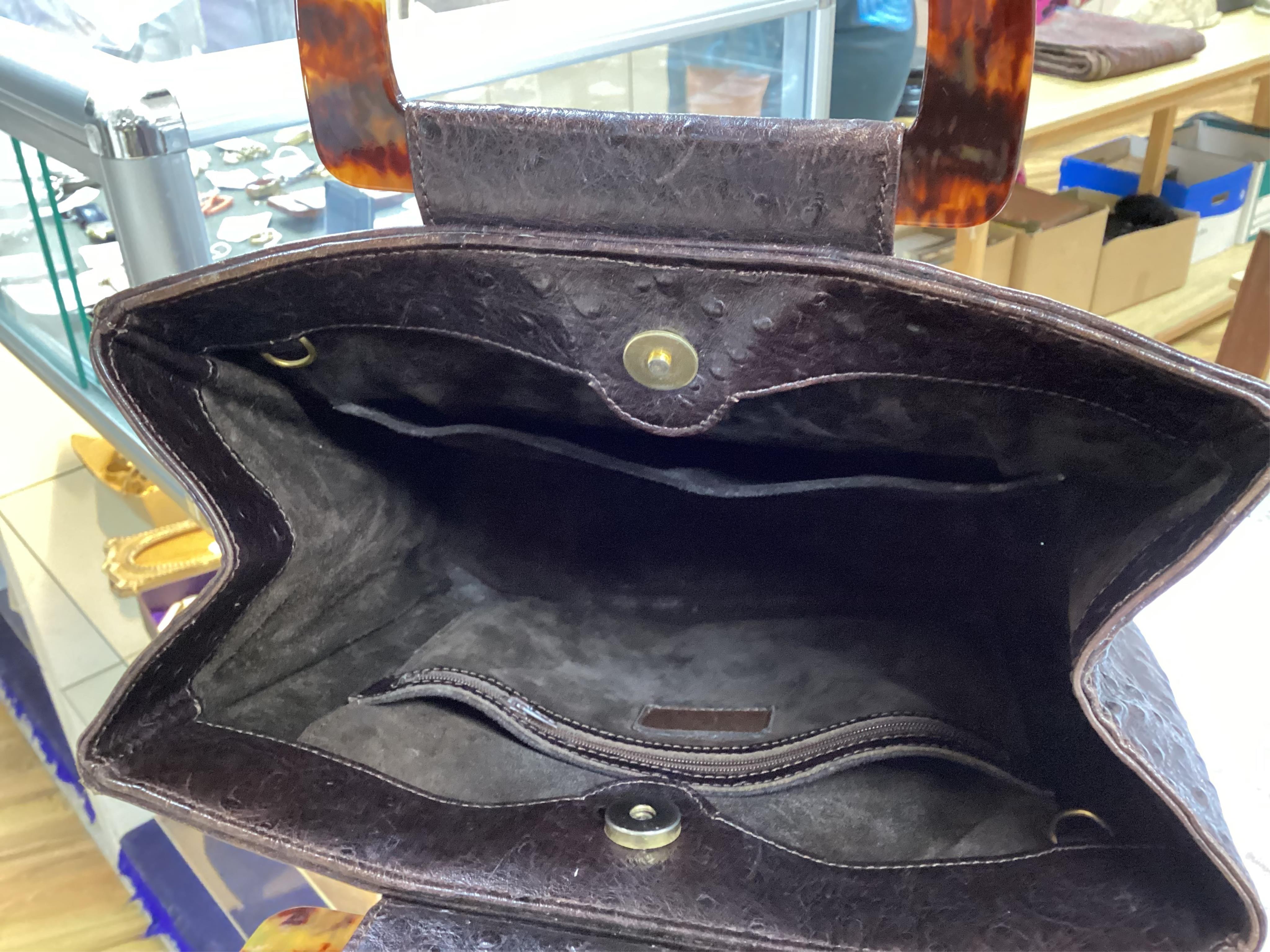 A brown Yves Saint Laurent handbag with faux tortoiseshell handles, ostrich leather with interior zip pocket